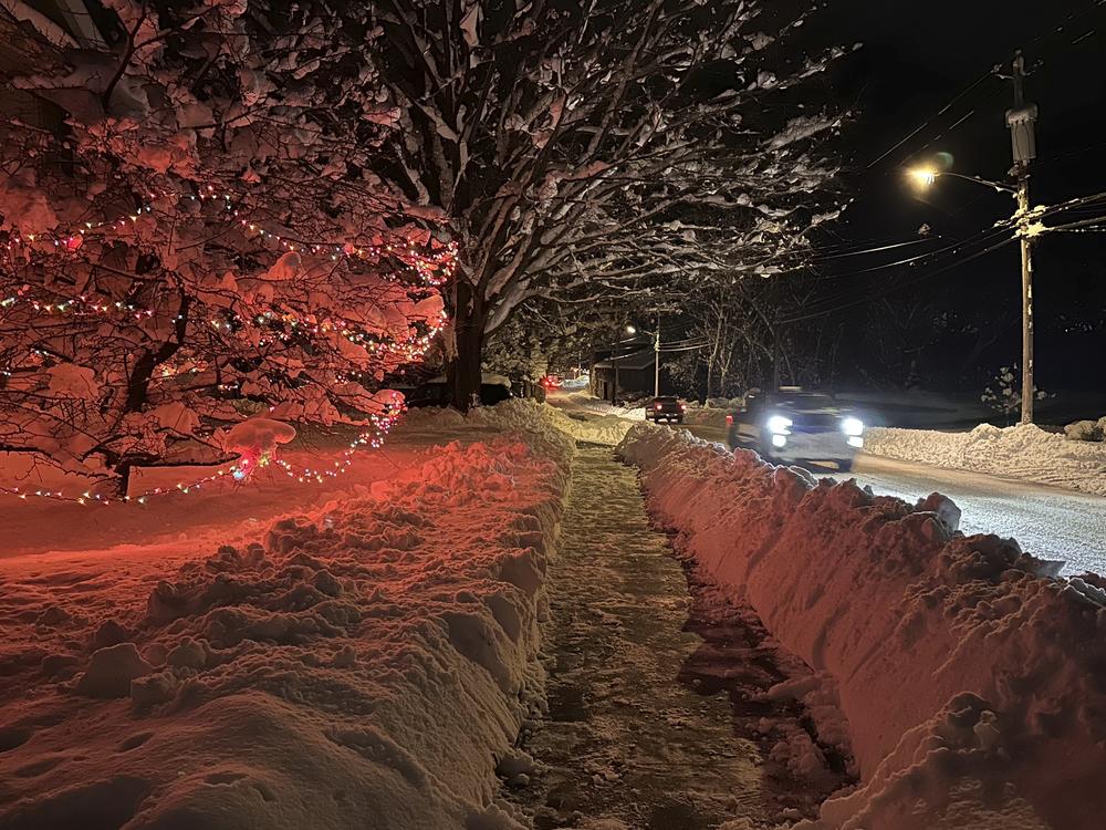 Drivers take advantage of the lull between lake-effect snowfalls in Lowville, N.Y., on Saturday.