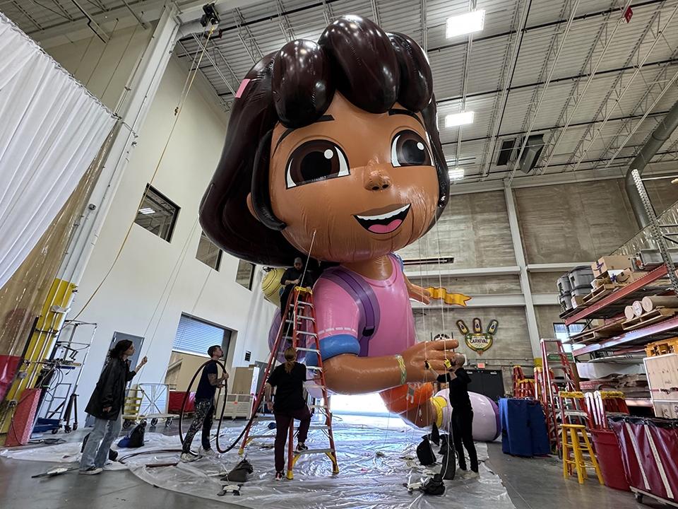 The Dora the Explorer balloon gets pumped up for a flight over the streets of New York City in the 98th Macy's Thanksgiving Day Parade.