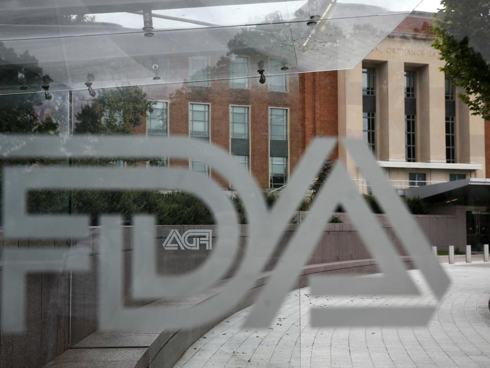 A U.S. Food and Drug Administration building is seen behind FDA logos at a bus stop on the agency's campus in Silver Spring, Md., in 2018. Cucumbers shipped to the U.S. and Canada, and organic eggs sold in 25 Costco stores in five southern U.S. states, were recalled this week for potential salmonella contamination.