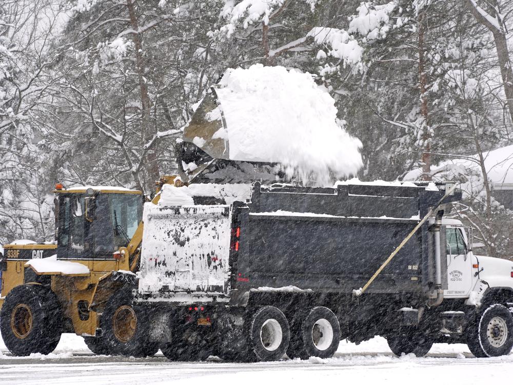 Snow is cleared from a Highmark Stadium parking lot for a Sunday Night Football game between the Buffalo Bills and the San Francisco 49ers on Sunday in Orchard Park, N.Y.