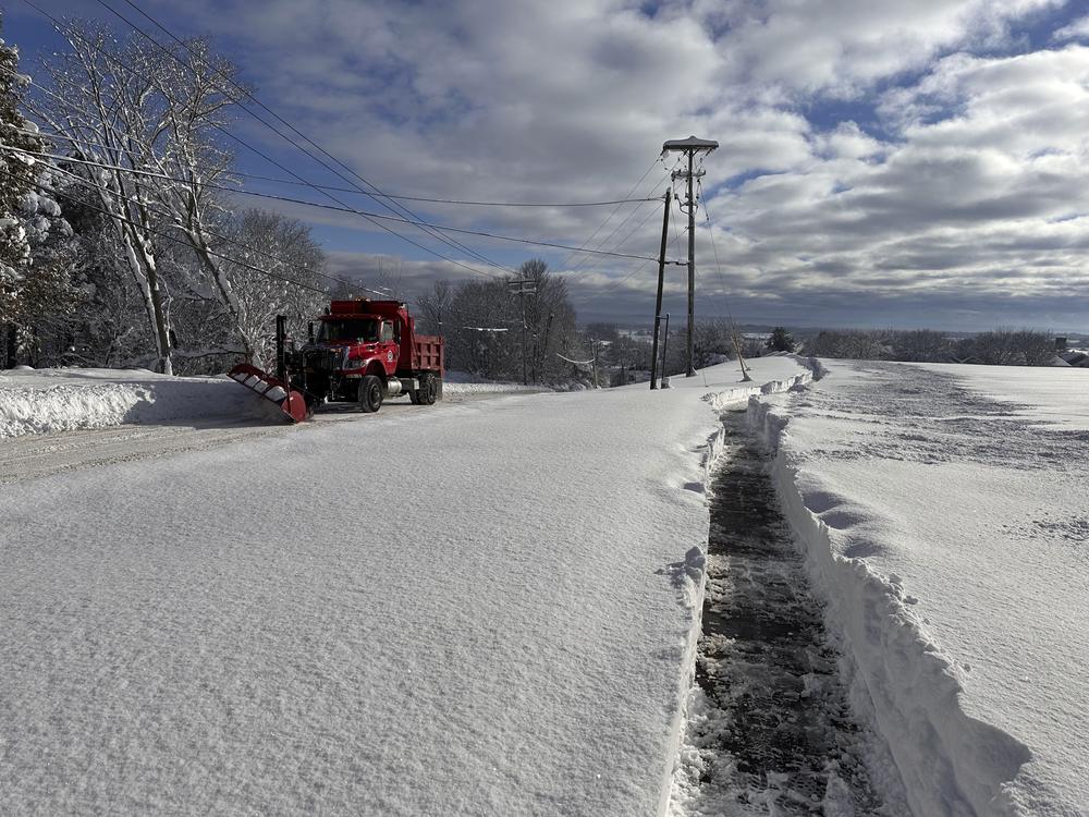 A snowplow on rounds in Lowville, N.Y., on Monday, Dec. 2, 2024. The region is cleaning up after feet of snow.