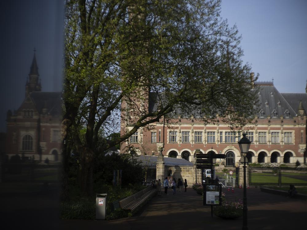 The Peace Palace housing the World Court, or International Court of Justice, is reflected in a monument in The Hague, Netherlands.