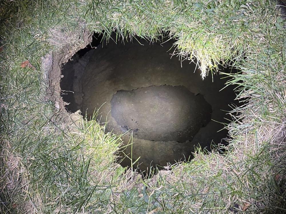 This Tuesday, Dec. 3, 2024. image provided by the Pennsylvania State Police shows the top of a sinkhole in the village of Marguerite, Pa., where rescuers were searching for a woman who disappeared.