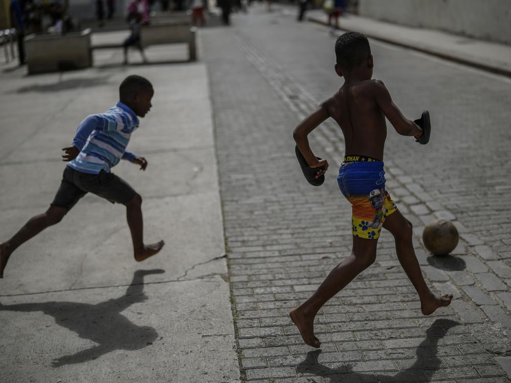 Children kick a ball around during a power outage in Havana, Cuba, on Wednesday.