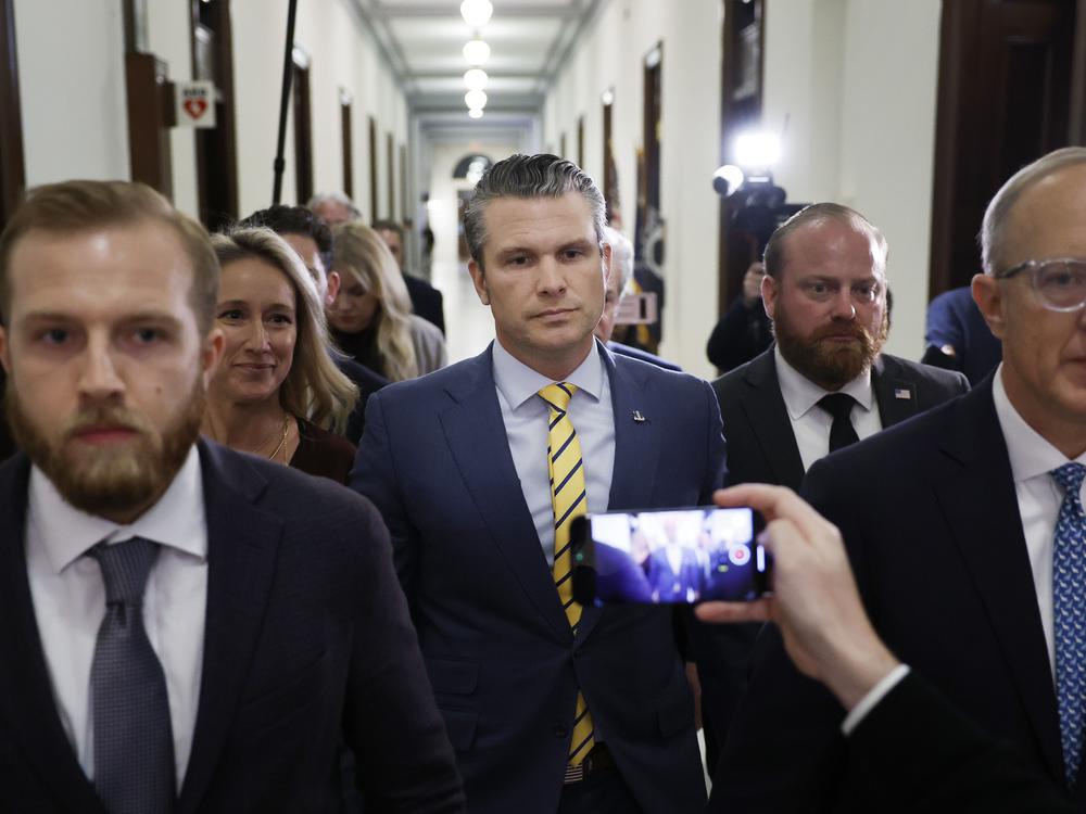 Pete Hegseth, President-elect Donald Trump's nominee to be Secretary of Defense, and his wife Jennifer Rauchet walk through the Russell Senate Office building on Capitol Hill on Dec. 3, 2024.