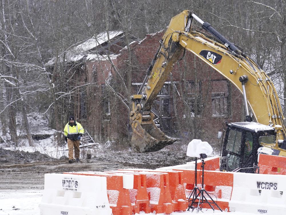 Rescue workers search on Thursday for Elizabeth Pollard, who is believed to have disappeared in a sinkhole while looking for her cat, in Marguerite, Pa.