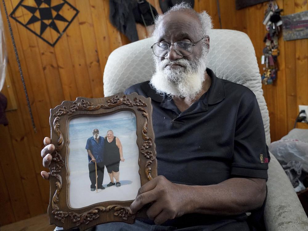 Kenny Pollard, 75, holds a photo in his home from a vacation that he and his wife, Elizabeth, took to Clearwater Beach, Fla., approximately 10 years ago.