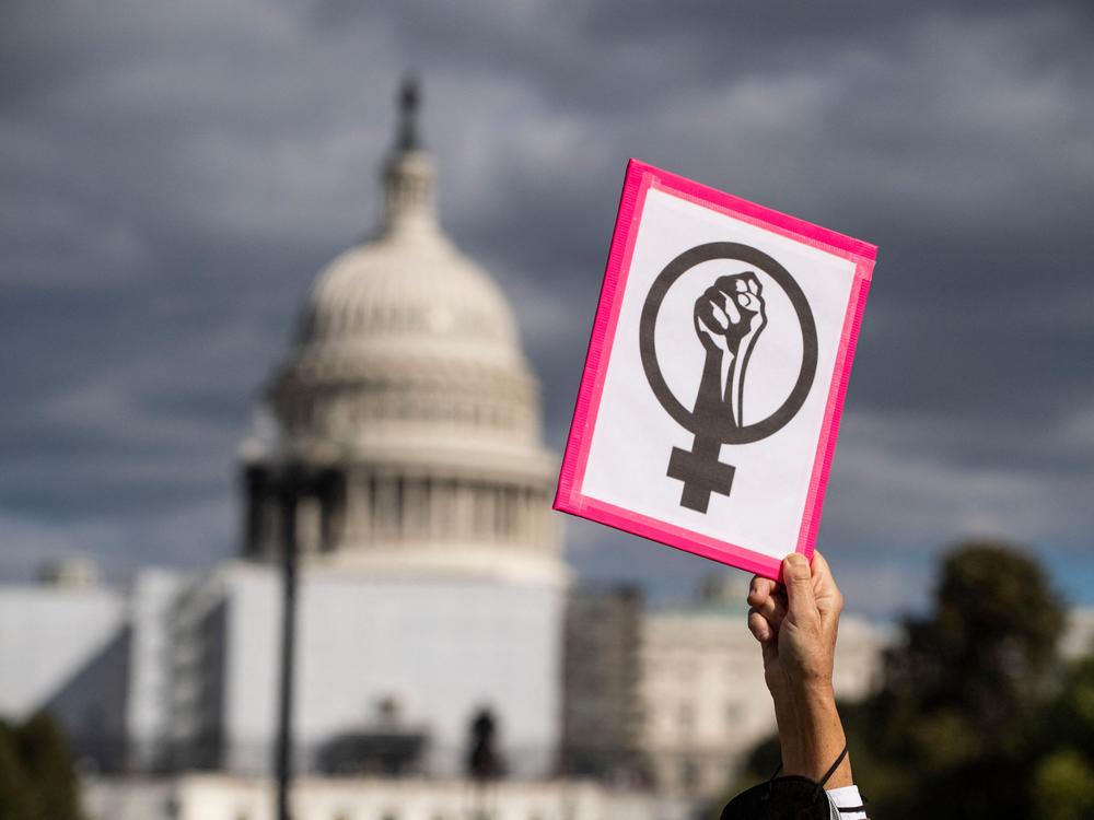 An abortion rights demonstrator holds a sign near the U.S. Capitol during the annual Women's March to support Women's Rights in Washington, D.C., on Oct. 8, 2022.