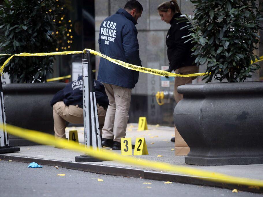 Police place bullet casing markers outside of a Hilton Hotel in Midtown Manhattan where UnitedHealthcare CEO Brian Thompson was fatally shot on Wednesday in New York City.