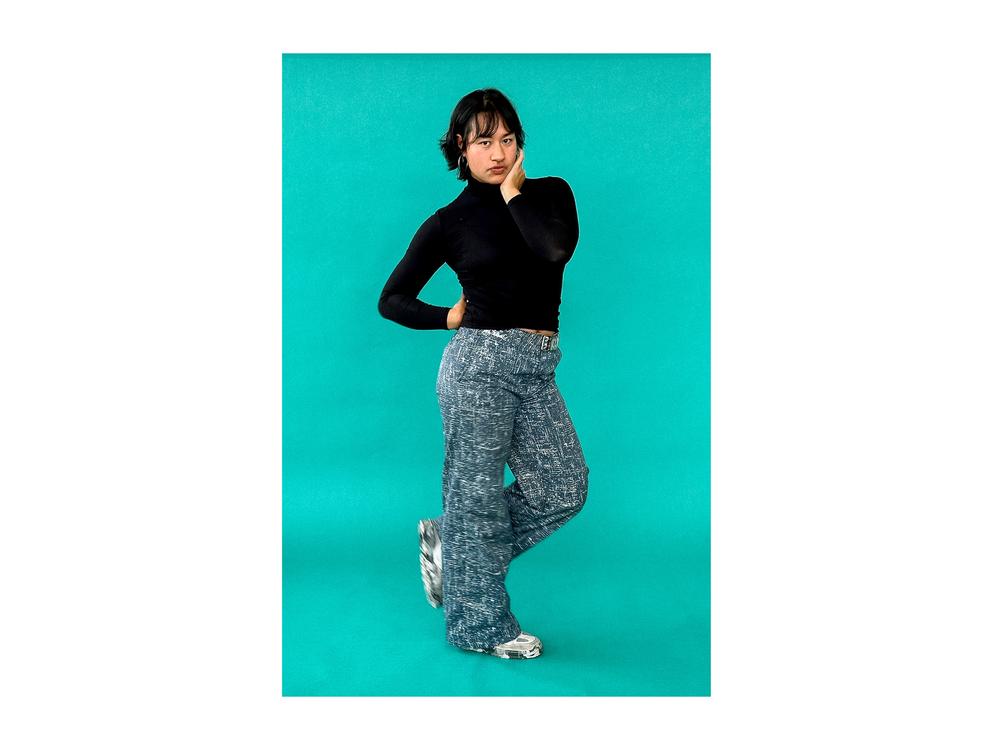 Life Kit producer Margaret Cirino plays with a modified hand-on-hip pose, raising her hand to the top of her butt and crossing her legs.