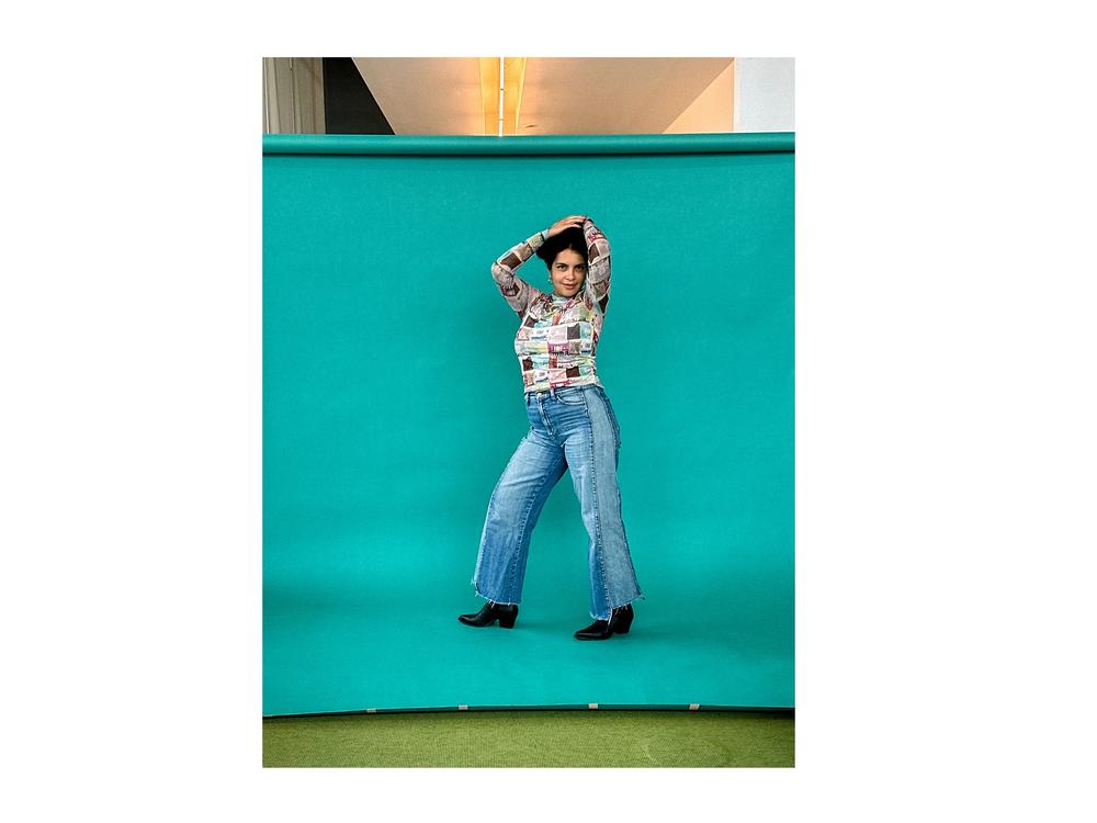 Gharib adds visual interest to her pose by raising her arms over her head, a tip that model Stephanie Yeboah recommends.