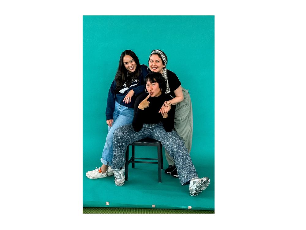 Cirino (center) embodies a seated version of the wide-leg 