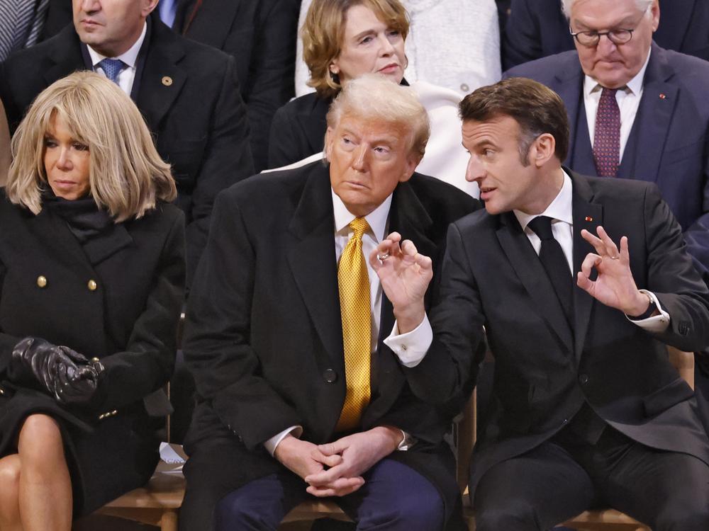 French President Emmanuel Macron, right, talks with U.S. President-elect Donald Trump in Notre Dame Cathedral as France's iconic cathedral is formally reopening its doors for the first time since a devastating fire nearly destroyed the landmark in 2019.