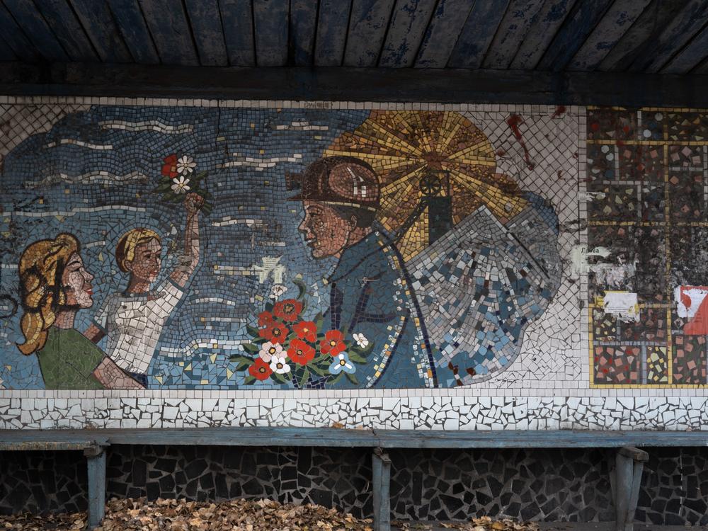 A Soviet-era mosaic celebrating coal miners at a bus stop in Dobropillya, Ukraine. Like the nearby coal mining center of Pokrovsk, Dobropillya frequently comes under aerial attack from Russian missiles and drones.