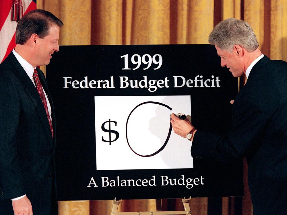 Vice President Al Gore (left) looks on as President Bill Clinton (right) places an 