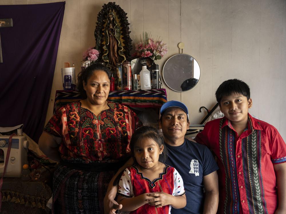 Baldomero Orozco-Juarez, his wife, Silvia García, and their children sit for a portrait at their home.