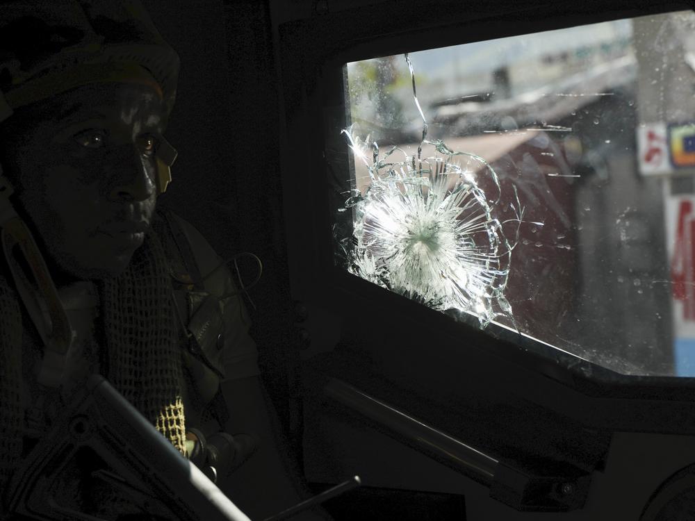 A Kenyan police officer, part of a U.N.-backed multinational force, patrols a street in Port-au-Prince, Haiti, on Dec. 5.