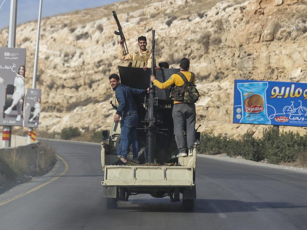 Syrian opposition fighters drive along the Damascus-Beirut highway, Syria.