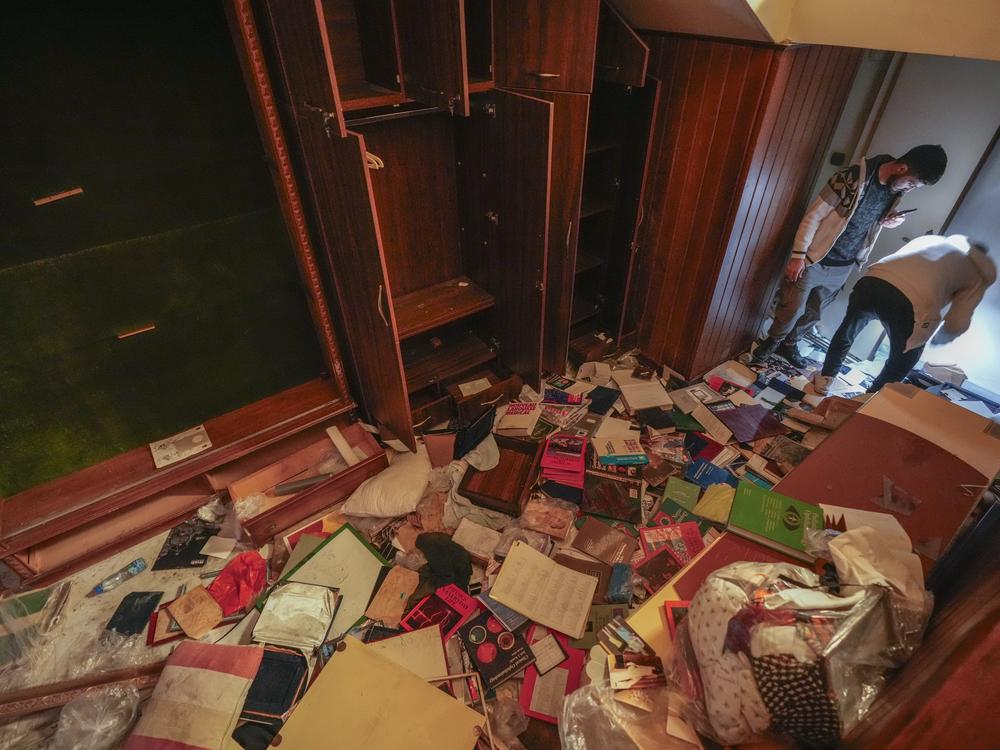 People search for belongings in the ransacked private residence of Syrian President Bashar Assad in the Malkeh district of Damascus, Syria, on Sunday.