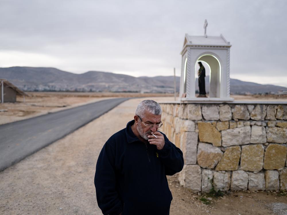 Rafaat Nasrallah smokes a cigarette in his village on the Syria-Lebanon border. 