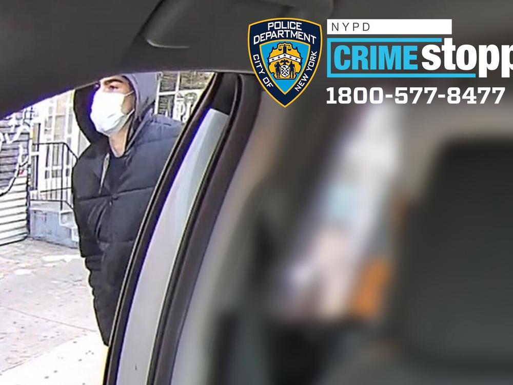 This undated photo released by the New York Police Department shows a suspect in the fatal shooting of UnitedHealthcare CEO Brian Thompson on Dec. 4, 2024, outside of a taxi. Part of the image was blurred by the source.