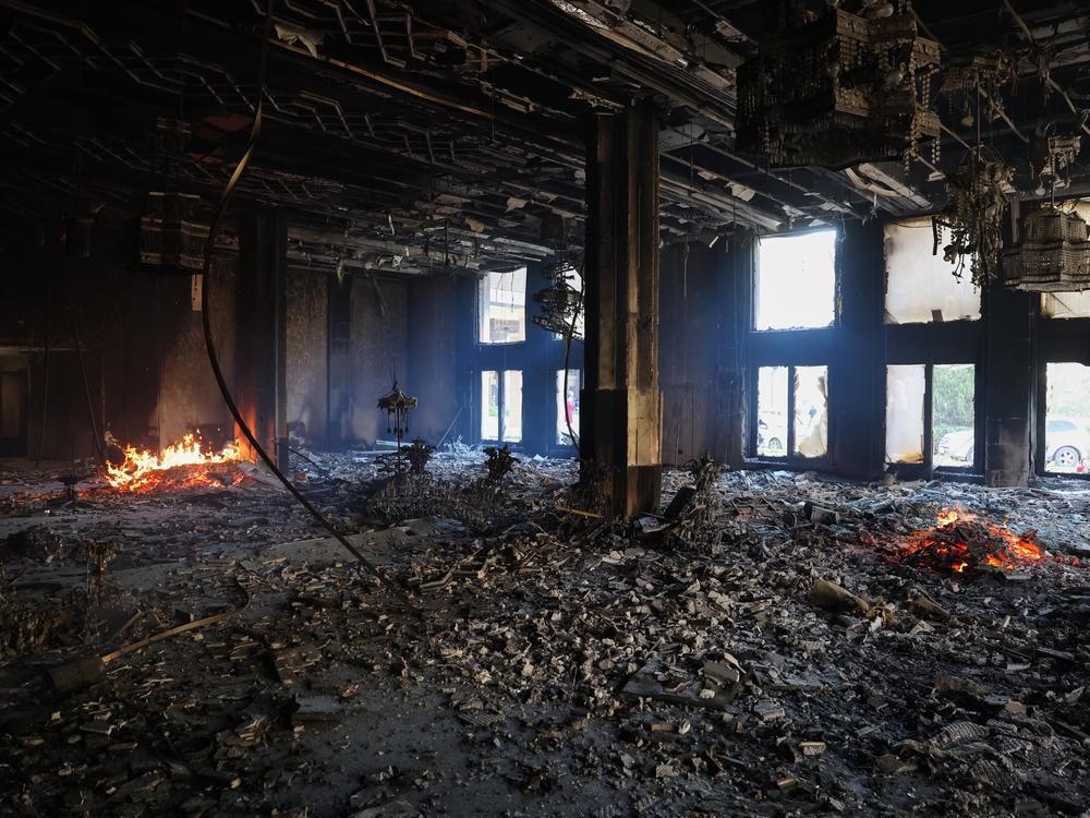 A fire burns in a room of the Tishrin residential palace of Syria's ousted president Bashar al-Assad in Damascus' al-Muhajirin area.
