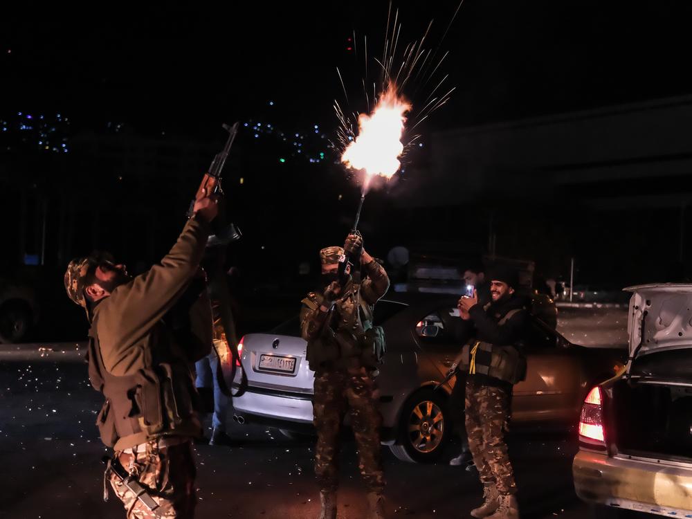 Members of armed groups celebrate by shooting into the air at the Umayyad Square after sixty-one years of Baath Party rule in Syria collapses on Sunday when, the capital fell out of the hands of regime control in Damascus, Syria.