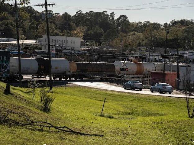 A freight train runs past the Koch Foods plant in Morton. Chicken processing plants like this one form the backbone of the local economy, and rely on immigrant labor.