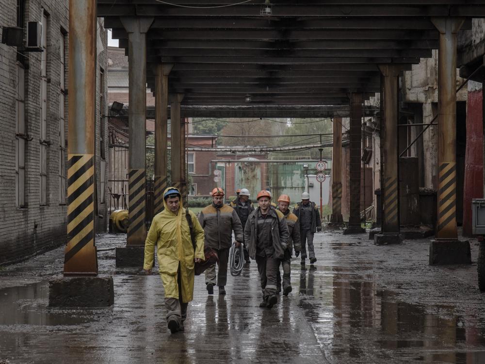 Workers at a DTEK power plant under repair head to work on the morning shift.