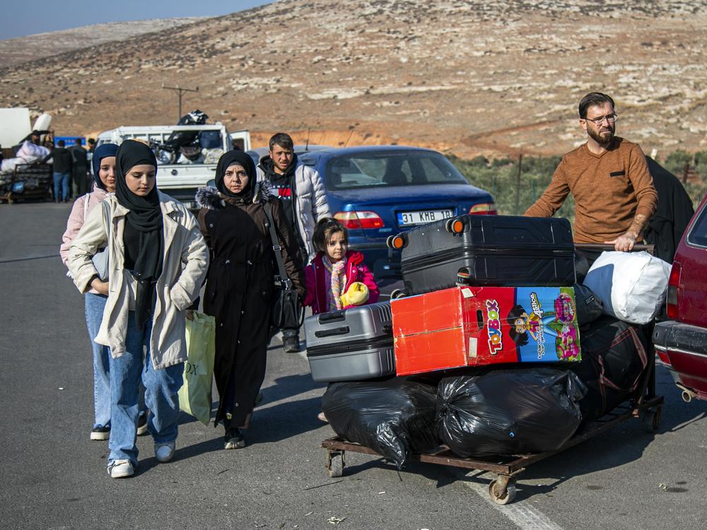 Syrians who have been refugees in Turkey arrive at the Turkey-Syria border crossing near the Turkish town of Antakya as they return to their homeland. Some 3 million Syrians have been living in Turkey.