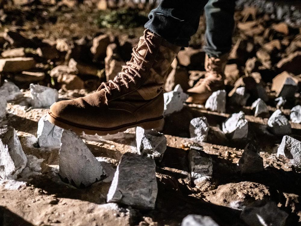 A member of the Elephant Response Team navigates walls of jagged rocks — a form of elephant deterrent currently being tested.