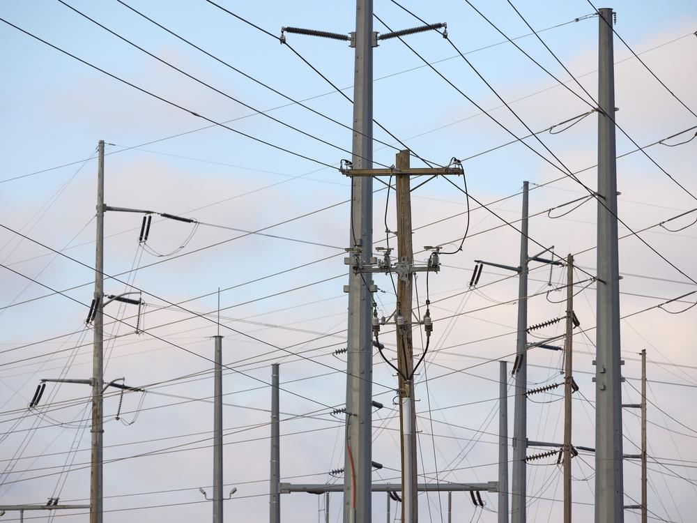 Transmission lines and electricity infrastructure adjacent to a construction site for an Amazon Web Services data center in Hilliard, Ohio. Because nuclear takes so long to develop, some fear that AI will be powered by natural gas for the foreseeable future.