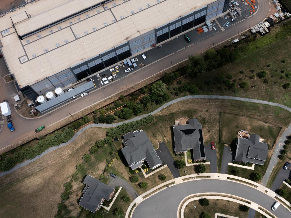 An Amazon Web Services data center is shown situated near single-family homes on July 17, 2024 in Stone Ridge, Virginia. AI datacenters may soon require a gigawatt of electricity to run—the equivalent of around a million households.