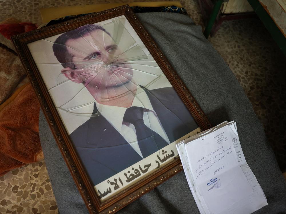 A portrait of Syrian President Bashar al-Assad with its frame broken, in the Political Security Branch facility on the outskirts of the central city of Hama, following the capture of the area by anti-government forces this past weekend.