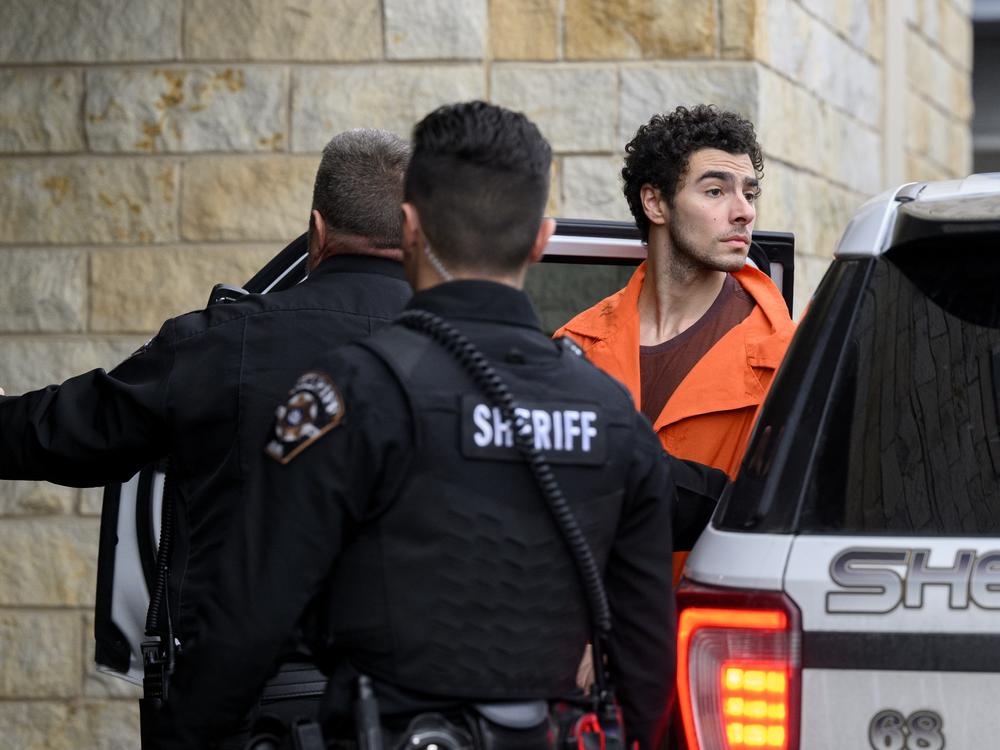 Suspected shooter Luigi Mangione is led into the Blair County Courthouse for an extradition hearing on Tuesday in Hollidaysburg, Pa.