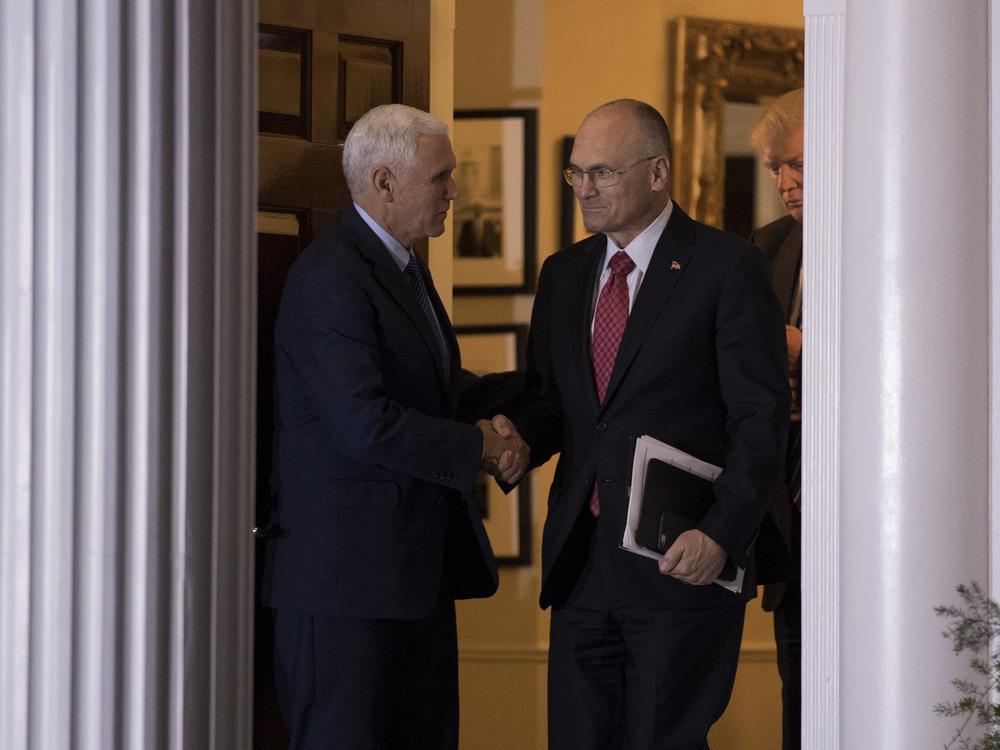 Just weeks after the 2016 election, Andrew Puzder shakes hands with then-Vice President-elect Mike Pence after a meeting with President-elect Trump at his golf club in New Jersey.