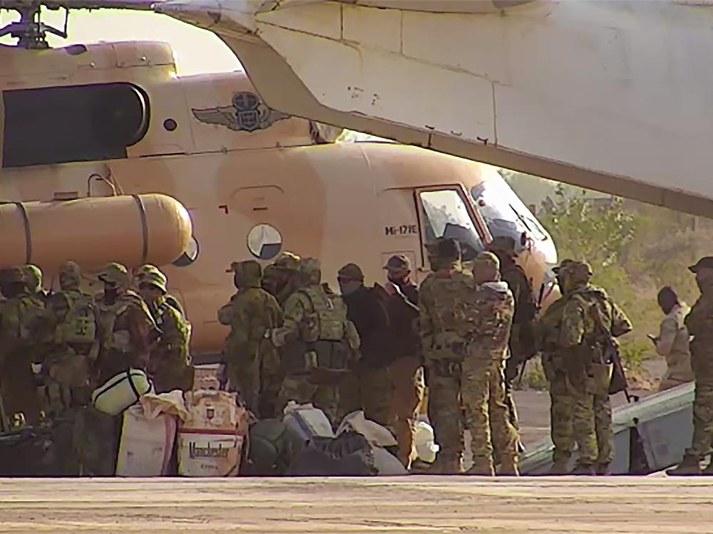 This undated photograph released in April 2022 by France's military shows Russian mercenaries boarding a helicopter in northern Mali.]