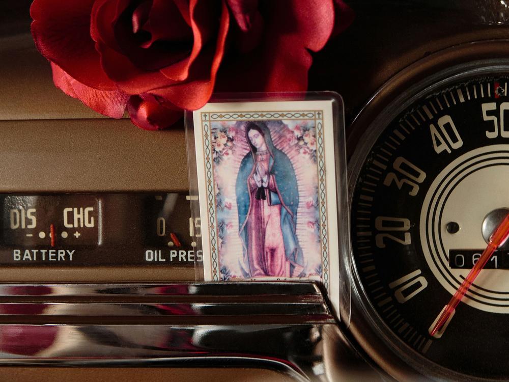 <em>Dashboard Altar,</em> San Francisco, California, 2019. A Guadalupe prayer card is displayed in Professor John Ulloa's 1948 Chevy Fleetline Aerosedan.
