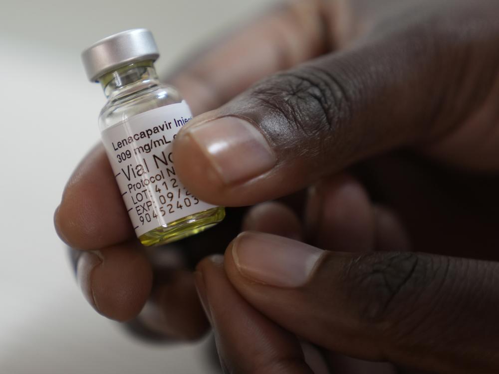 A pharmacist holds a vial of lenacapavir, at the Desmond Tutu Health Foundation's Masiphumelele Research Site, in Cape Town, South Africa. The drug's development has been heralded as the 2024 Breakthrough of the Year by the journal <em>Science,</em> which described it as representing 
