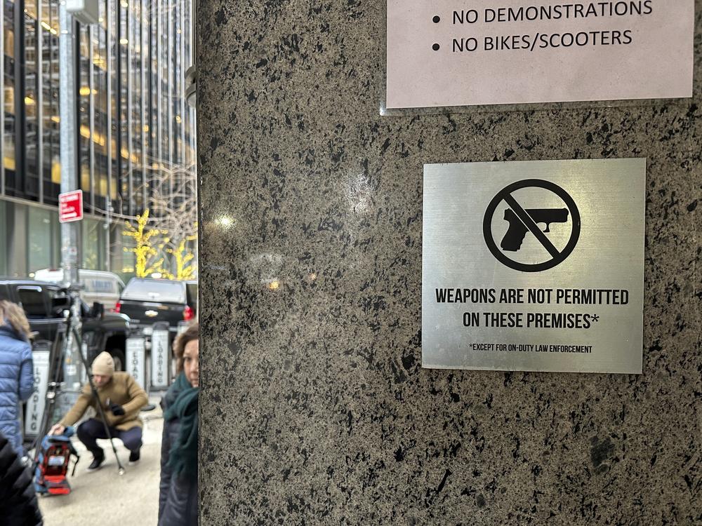 A no guns allowed sign is posted at the 54th Street entrance to the New York Hilton Midtown Hotel in New York, where Brian Thompson, the CEO of UnitedHealthcare, was fatally shot last week.
