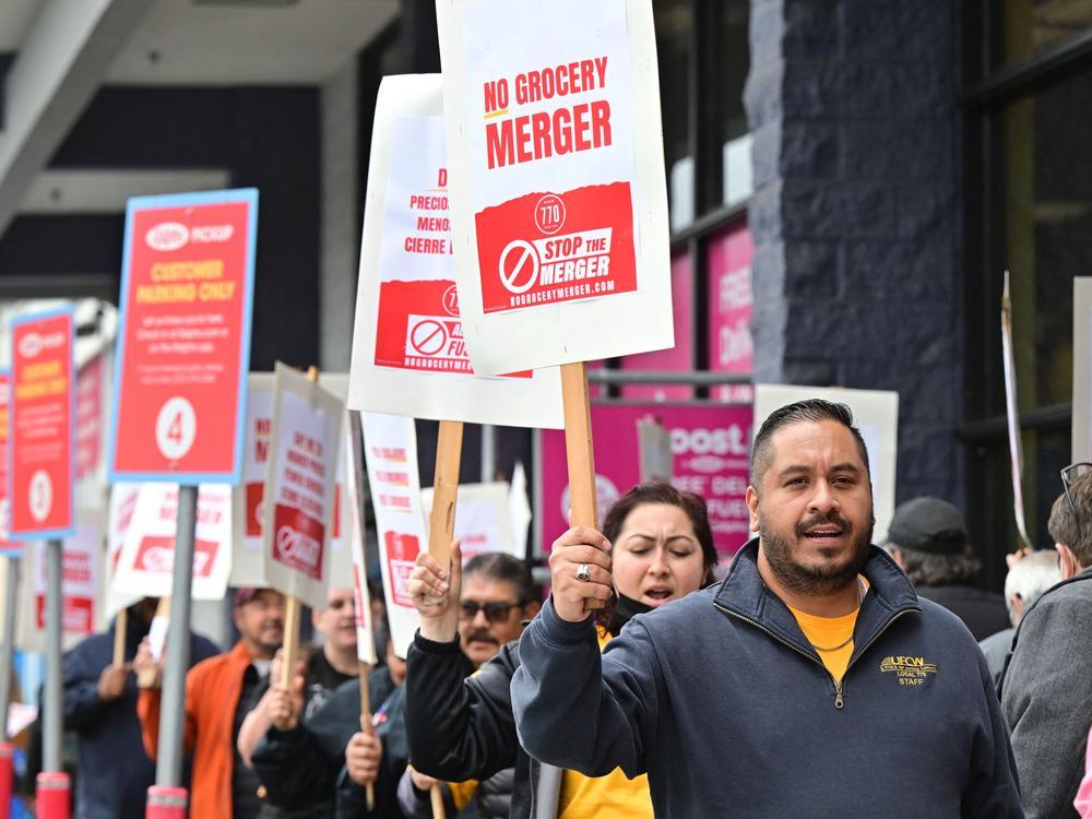Unionized grocery store workers rally to oppose the proposed merger between Kroger and Albertsons outside a Ralph's supermarket in Los Angeles in 2023. On Wednesday, Albertsons said it was giving up on the deal after it was blocked by two courts.