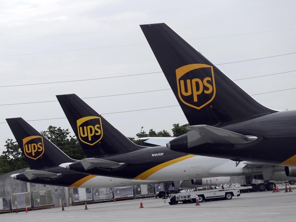 In this July 27, 2020, file photo, the tails of three UPS aircraft are shown parked at Miami International Airport in Miami.