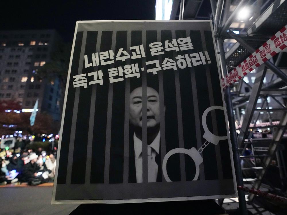 An image of depicting an imprisoned South Korean President Yoon Suk Yeol is displayed during a rally to demand his impeachment, on Friday, Dec. 13, 2024. The signs read 