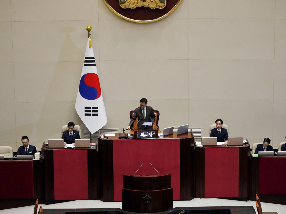 South Korean National Assembly Speaker Woo Won-shik, center, bangs with announcing the president impeachment after the impeachment vote of President Yoon Suk Yeol at the National Assembly in Seoul on Saturday.