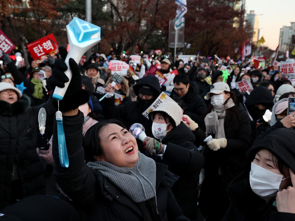 Protesters celebrate as the parliament votes to impeach South Korean president Yoon Suk Yeol over his decision to impose a martial law, in front of National Assembly on Saturday, in Seoul.