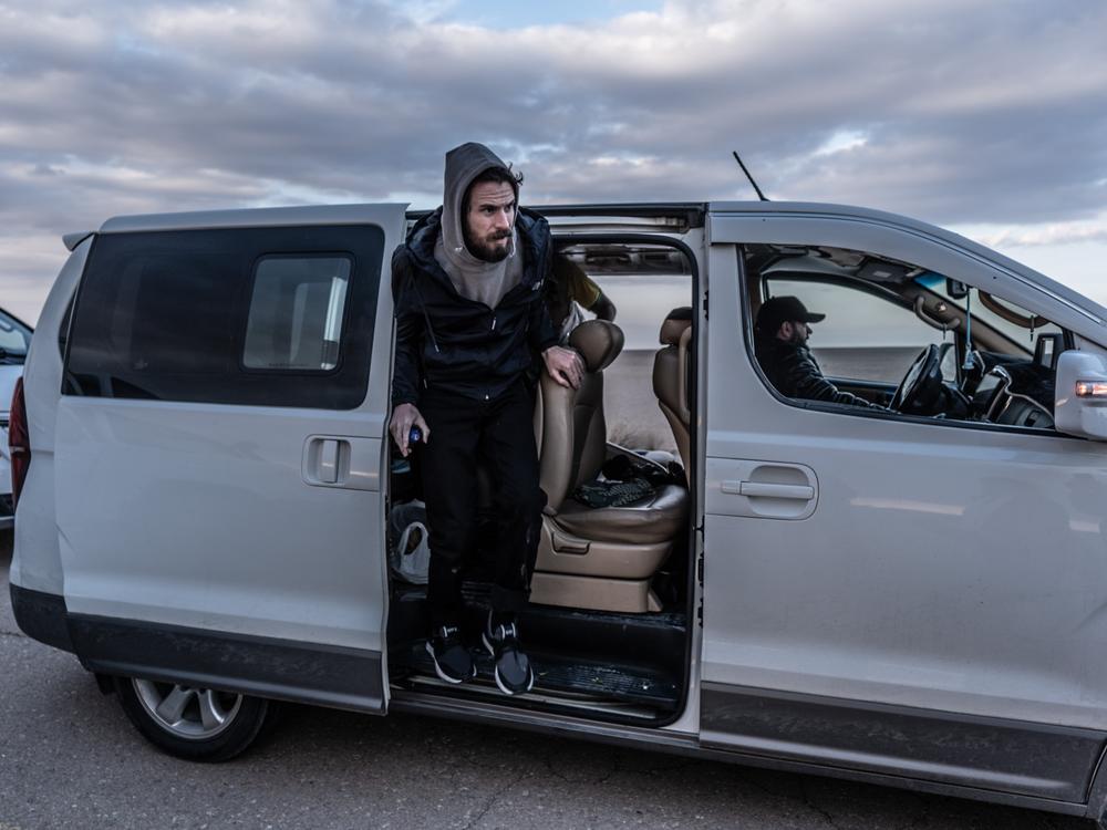 Timmerman gets out of a van ahead of his transfer to U.S. forces on the desert highway on Friday.