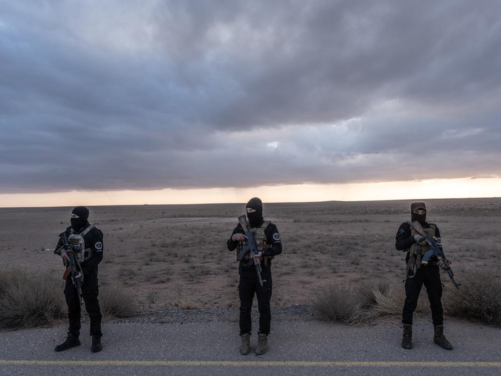 Syrian forces with Hayat Tahrir al-Sham, which led the overthrow of Bashar al-Assad's regime, secure the area where Timmerman is transferred to U.S. forces near the Syrian border with Iraq and Jordan.
