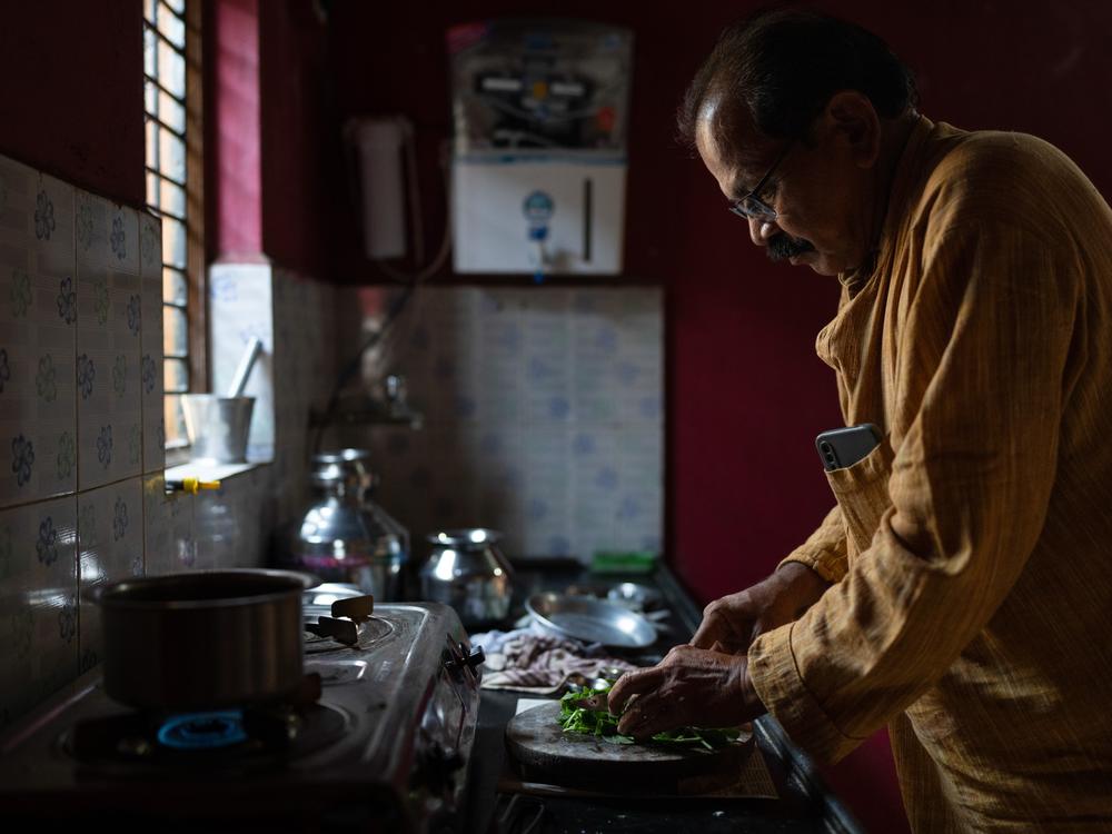 Shahu Patole prepares food in his mother's kitchen in Khamgaon, India. He's the author of the cookbook <em>Dalit Kitchens of Marathwada.</em>
