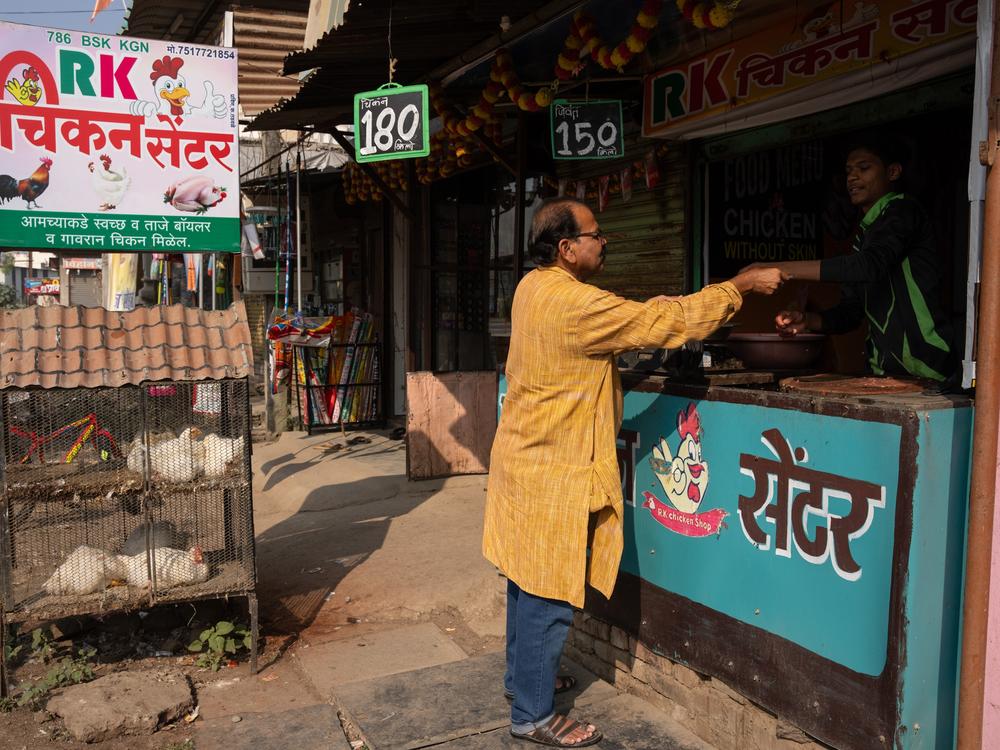 Shahu Patole buys meat at a butcher near his home. His cookbook, says one academic, 