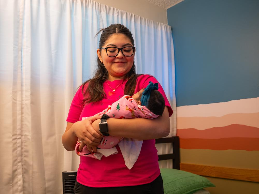 A certified nursing assistant comforts an infant who recently arrived at Jacob's Hope, a specialty nursery in Mesa, Arizona, that helps care for substance-exposed newborns and their parents.
